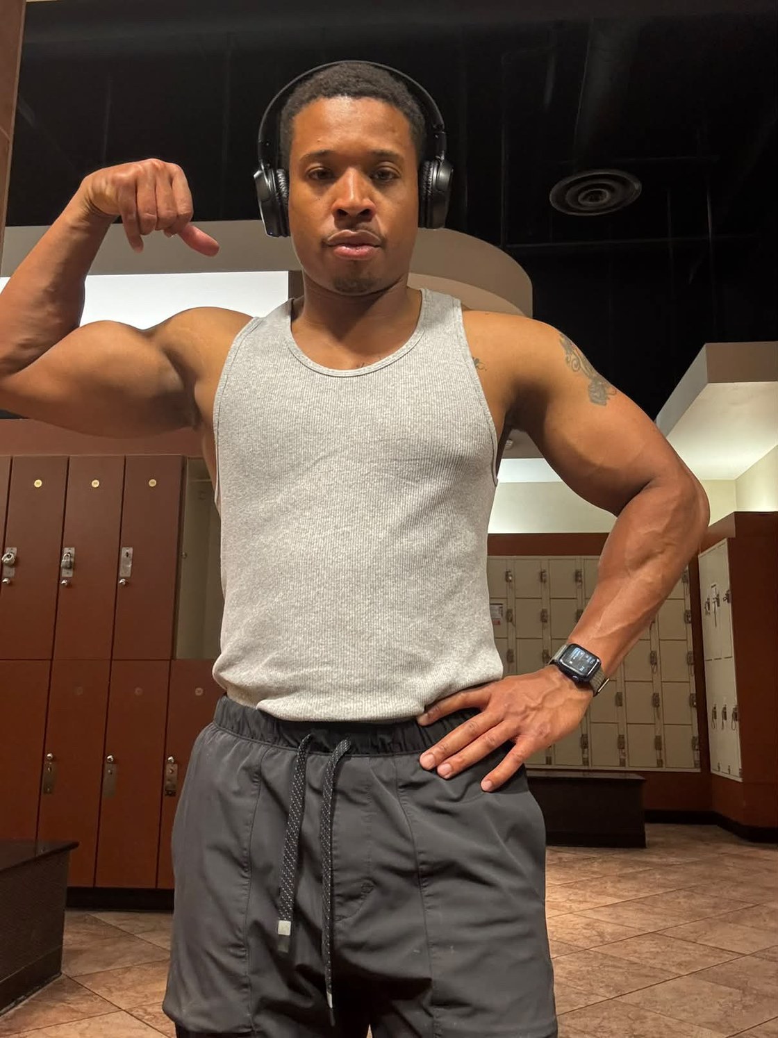 Dustin King, flexing and looking at the camera.